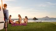 Campers relaxing on a New Zealand bay area
