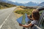 Map reading in car close to the New Zealand Alps