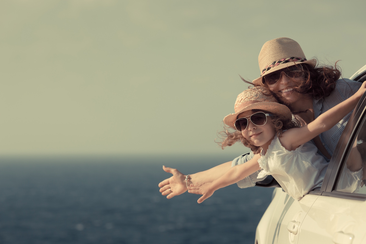 Woman and child at the beach. Summer vacations concept